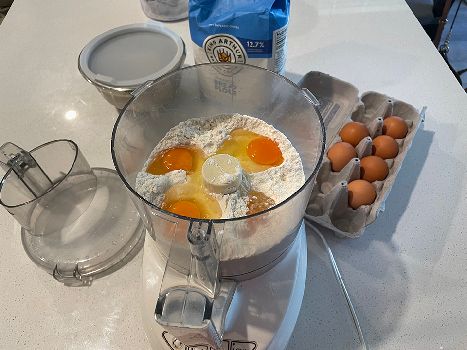 Place flour and eggs in food processor with dough hook